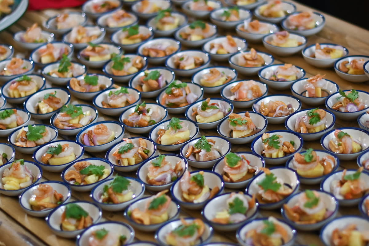 Yam Yanat tasting bowls plated for guests — ยำยานัดคำเตรียมเสิร์ฟผู้ร่วมงาน