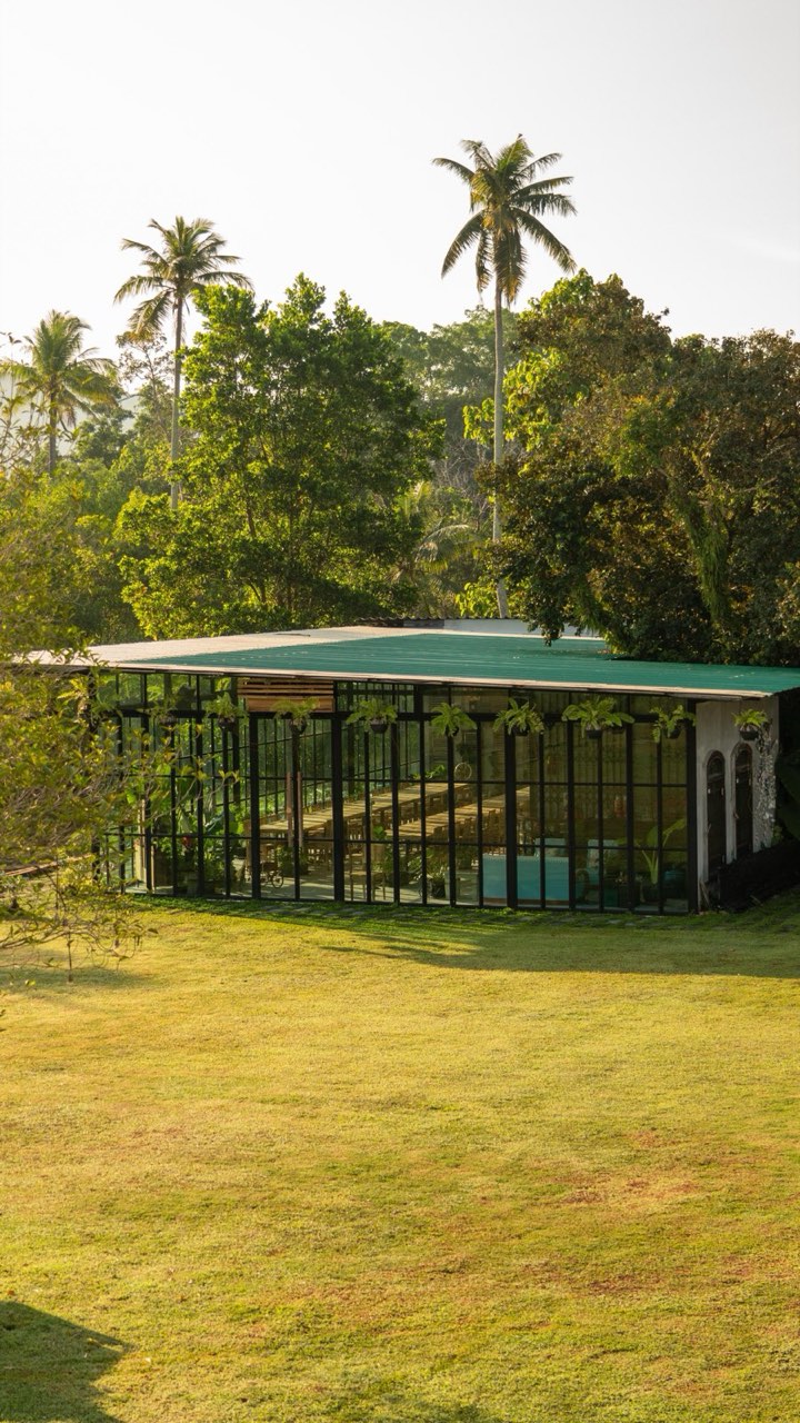 The open garden lawn at Baan Ar-Jor with the Wo-Ai-Ni glass house, set for large outdoor celebrations